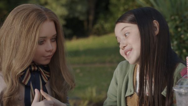 Violet McGraw is seen here with M3gan in a scene from Blumhouse M3gan