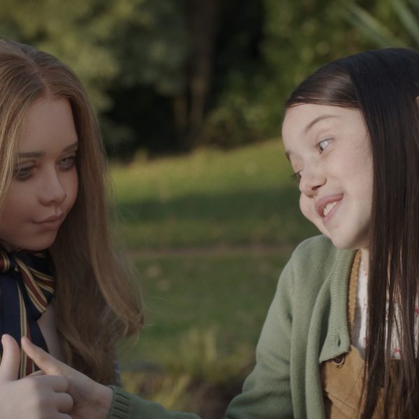 Violet McGraw is seen here with M3gan in a scene from Blumhouse M3gan