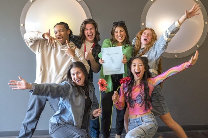 Daniella Monet poses with the new Hollywood Arts cast holding the script for the Victorious spinoff confirmed by Netflix.