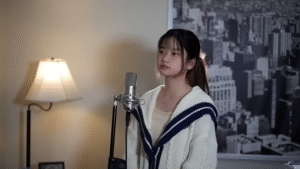 Shania Yan singing into a studio microphone during her cover of “Heal the World.”