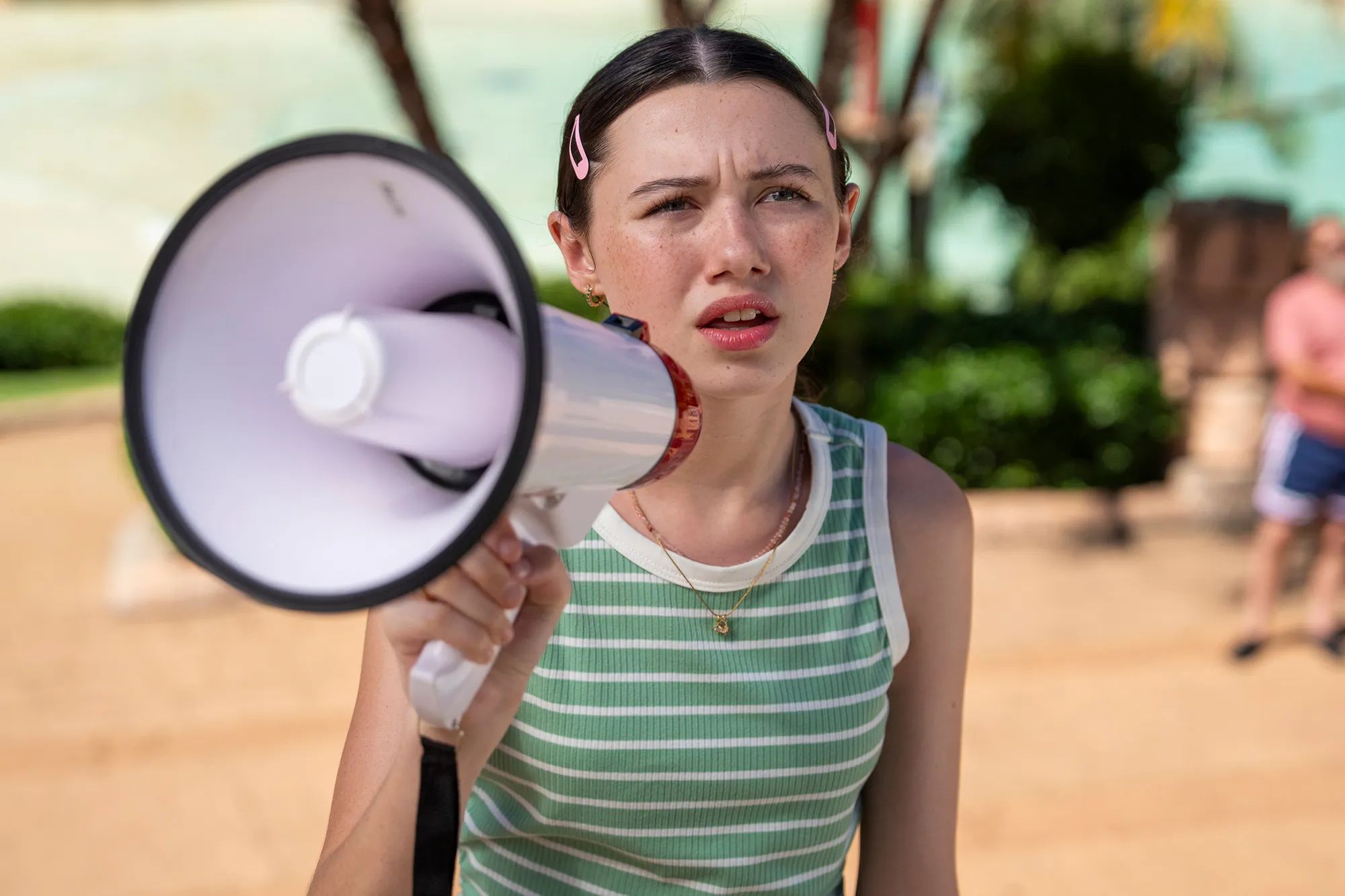 Violet McGraw as Summer in Summer's Last Resort, holding a megaphone at a resort with a wary look on her face.