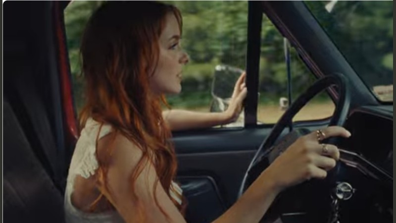 Mckenna Grace driving in the official music video for Bones and All