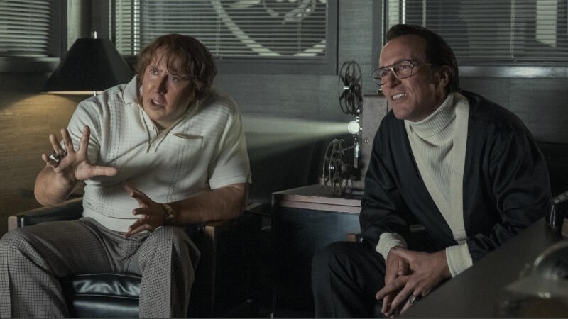 Nicolas Cage as John Madden and Christian Bale as Al Davis seated together in conversation in Madden