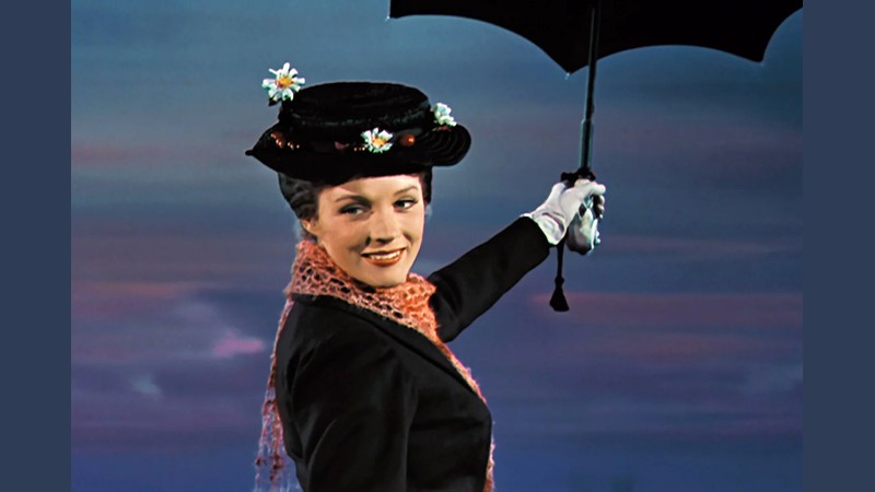 Julie Andrews as Mary Poppins holding her umbrella in the 1964 Disney film