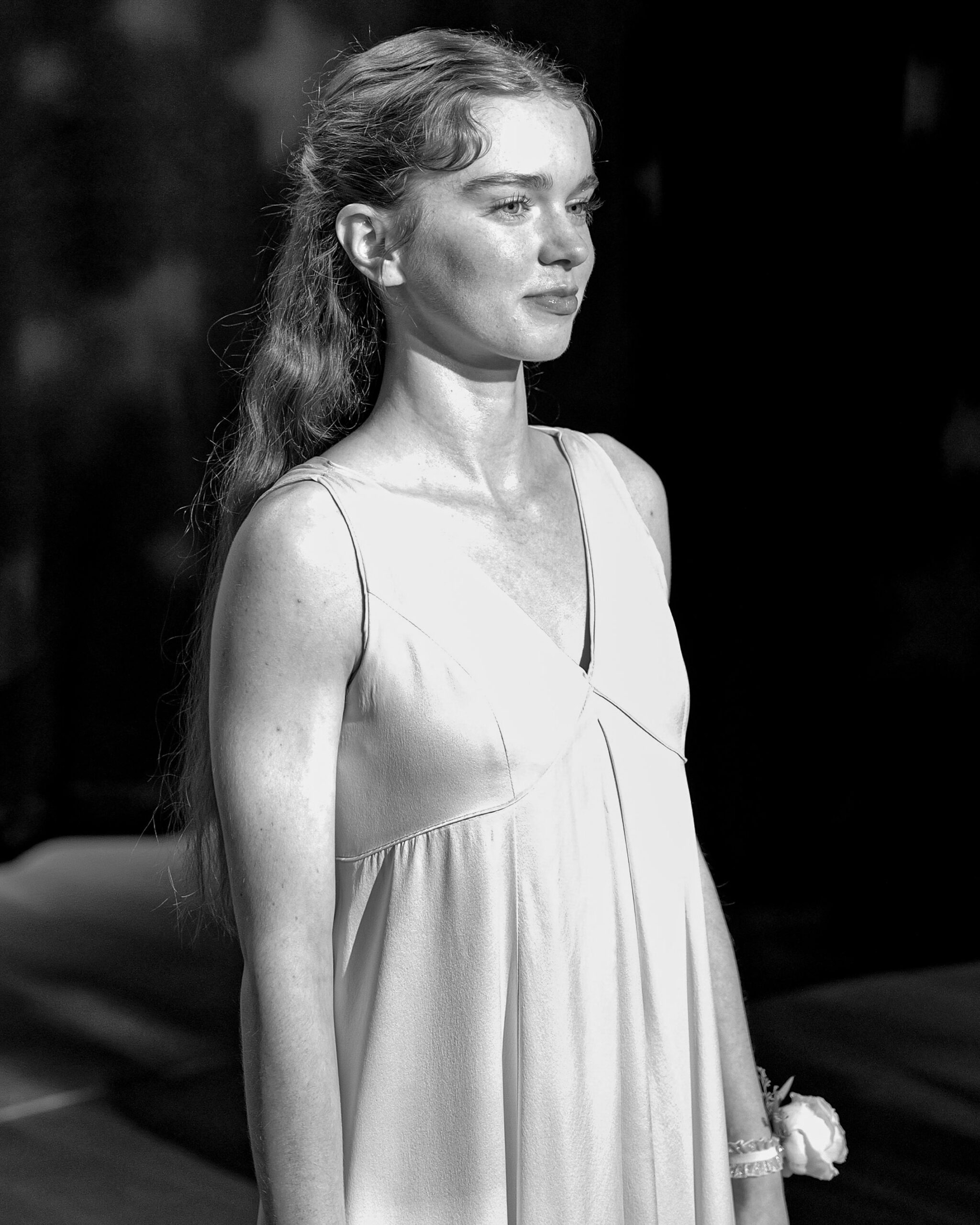Black and white portrait of Summer H. Howell between setups on the Carrie set