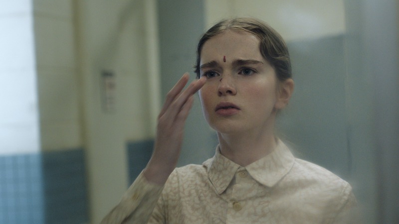 Summer H. Howell as Carrie White looking into a mirror with blood on her forehead in Prime Video's Carrie series