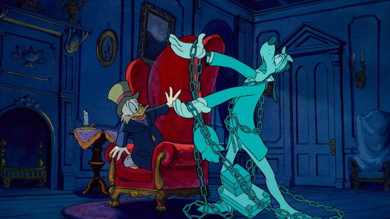 Scrooge McDuck recoils in his armchair as the ghost of Jacob Marley, played by Goofy, appears in chains in Mickey's Christmas Carol