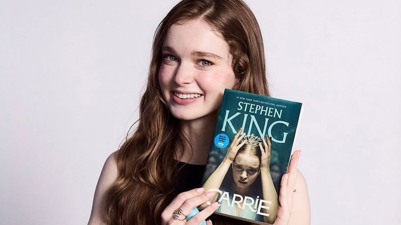 Summer H. Howell holding the new television tie-in edition of Stephen King's Carrie