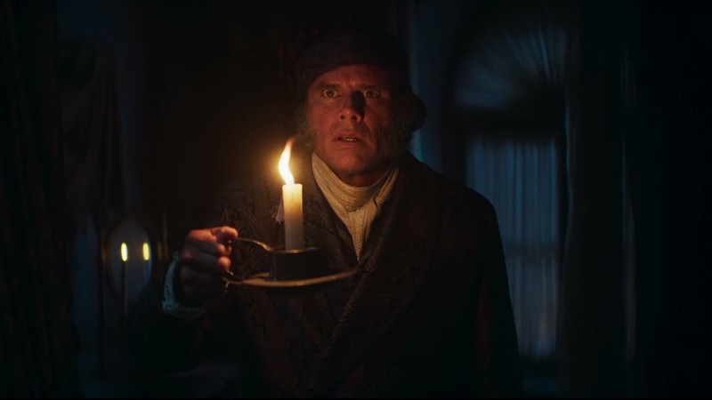 Walton Goggins as Ebenezer Scrooge holding a candle in A Who Knew Carol