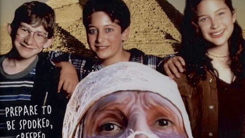 The three kids and Harold the mummy from the 1997 Under Wraps poster